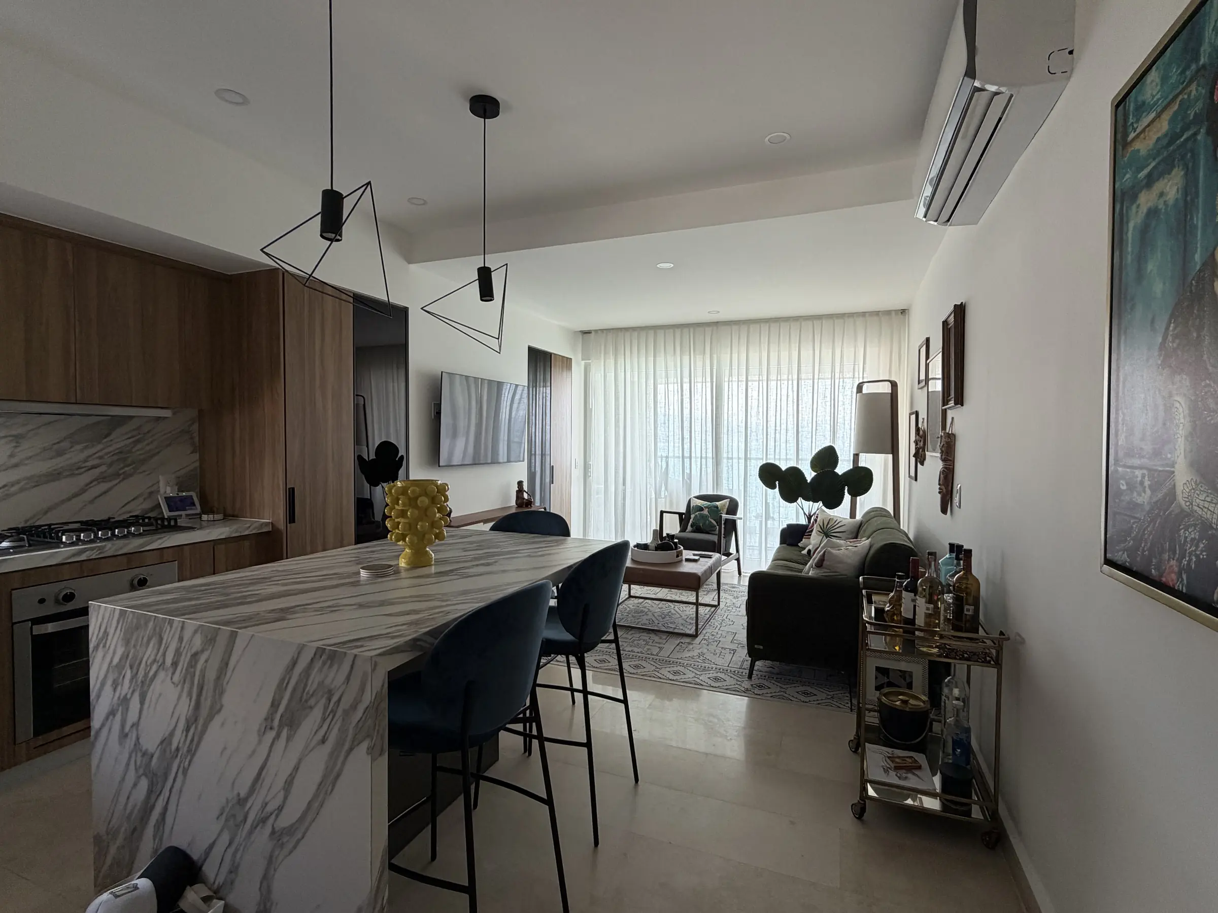 Open-plan living room and kitchen with marble island